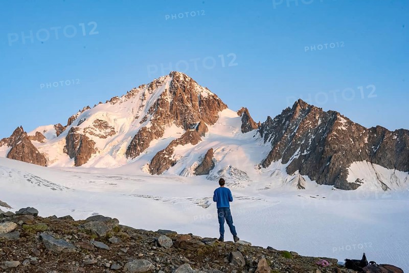 High alpine mountain landscape at sunset, Glacier du Tour, mountaineer in front of glacier and mountain peak, summit of Aiguille de Chardonnet, Chamonix, Haute-Savoie, France, Europe