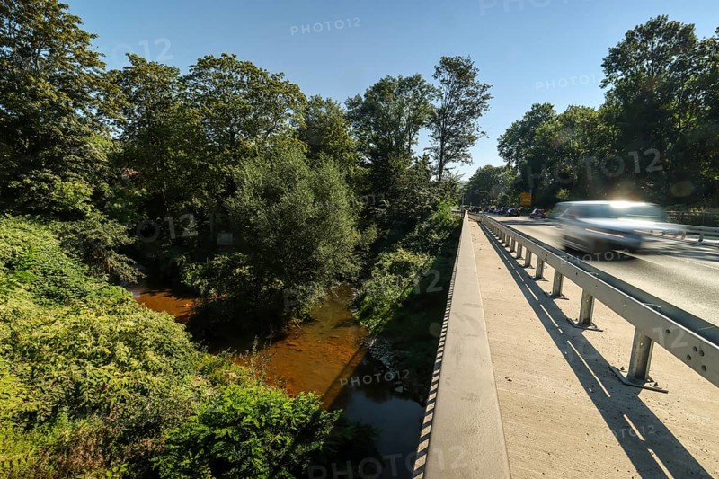 Witten, North Rhine-Westphalia, Germany - Mühlengraben in Witten, here red due to high iron content at the bridge on the B226 federal road shortly in front of it flows into the Ruhr