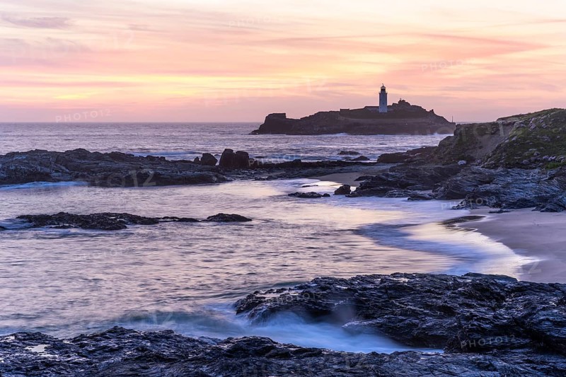 Godrevy Lighthouse, the lighthouse of Godrevy on Godrevy Island. In the evening at sunset. Long exposure. Cornwall, England, Great Britain