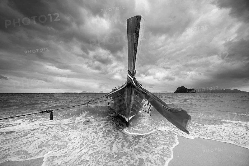 Longtail boat on the beach, dark rain clouds behind, Koh Ngai Island, Andaman Sea, Satun Province, Southern Thailand, Thailand, Asia