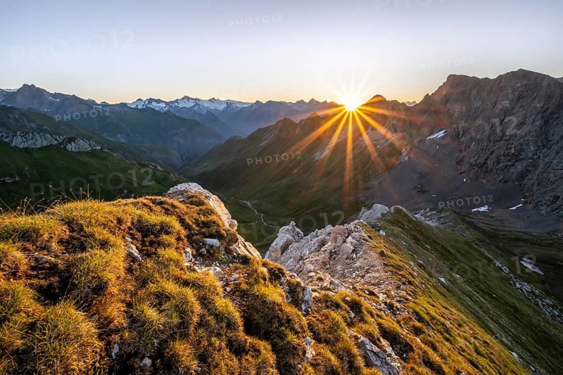 Mountain landscape at sunrise with sun star, view of mountain peaks of the Venediger group and into the Großbachtal valley from the summit of Bachlenkenkopf, Lasörling group, Hohe Tauern National Park, East Tyrol, Tyrol, Austria, Europe