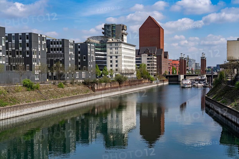 The Schwanentor Bridge in the inner harbour of Duisburg, one of 3 lifting bridges, can be raised up to 10 metres, freshly renovated, connects the city centre with the district of Kaßlerfeld, Ruhrort, tower of the former RWSG warehouse, today the seat of the State Archives of North Rhine-Westphalia, on the left the building of the LZPD, Germany, Europe
