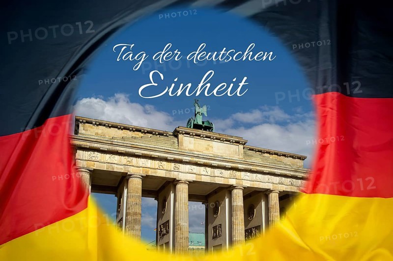 Brandenburg Tor in Berlin on a German flag (Composing), with the lettering DAY OF GERMAN UNITY