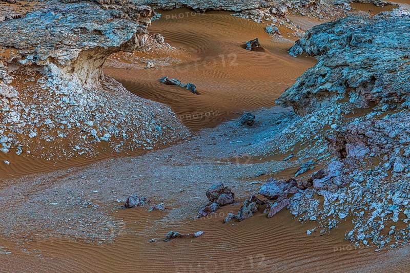 Striking cliffs surrounded by windswept sand structures, Huqf stone desert, Arabian Peninsula, Sultanate of Oman