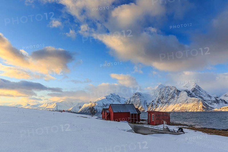 Red boathouses, coast, snowy mountains, fjord, morning light, clouds, snow, Lyngen Alps, Norway, Europe