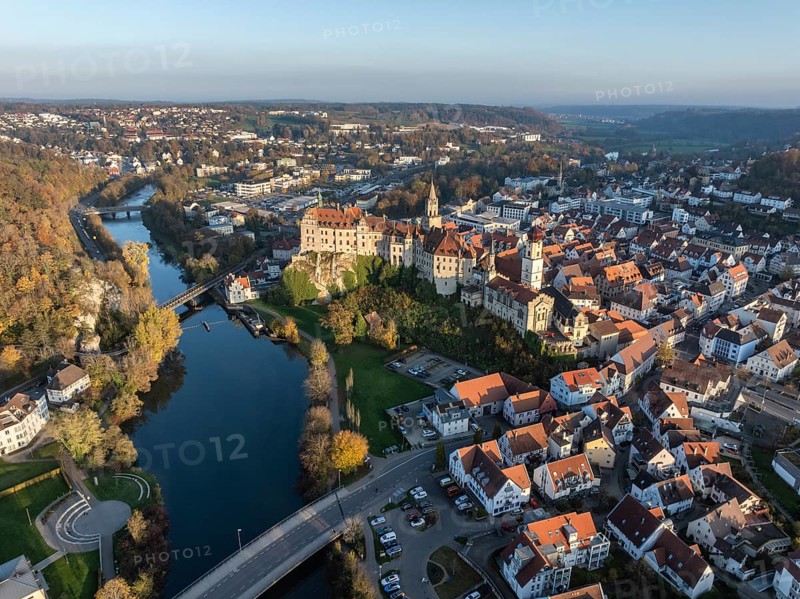 Aerial view of the town of Sigmaringen with the Hohenzollern Castle, a sight and tourist attraction above the old town and the Danube with autumnal vegetation, Danube valley, district of Sigmaringen, Baden-Württemberg, Germany, Europe