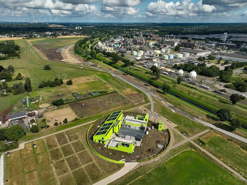 Oberhausen, North Rhine-Westphalia, Germany, renaturalisation of the Emscher in the Holtener Bruch. In front, the new Oberhausen pumping station. OQ Chemicals plant Ruhrchemie on the right. The Emscher, currently straightened, has been given curves again and can meander through its new floodplain. The ecological conversion of the Emscher system consists of the construction of a centralised wastewater treatment system in the Ruhr region, the construction of sewers and the renaturation of the Emscher and its tributaries. Following the construction of a parallel sewer, the Emscher has been completely free of sewage since January 2022. The river was previously an open, above-ground combined sewer with rainwater and wastewater, Europe