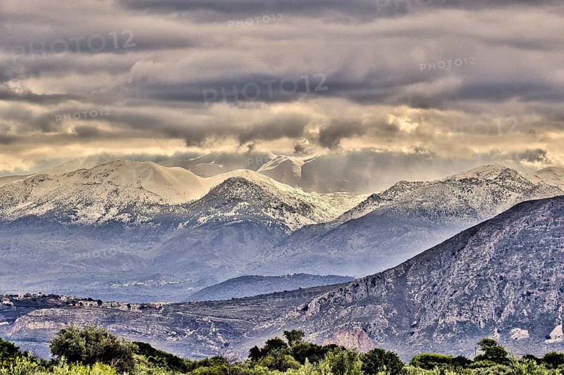 Snowy mountains under threatening grey clouds in a vast landscape with a dramatic atmosphere, Lefka Ori, White Mountains, mountain massif, West, Crete, Greece, Europe