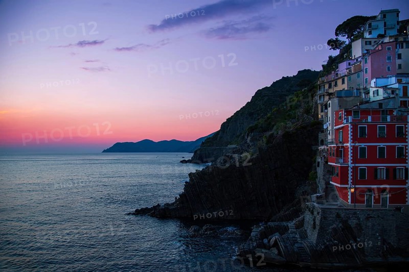 Italy, Riomaggiore colorful buildings overlooking scenic shoreline. Cinque Terre landscapes in Italy on Amalfi Coast, Europe