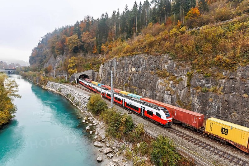 Train of the S-Bahn Vorarlberg and goods train of the Austrian Federal Railways ÖBB Eisenbahn in autumn in Feldkirch, Austria, Europe