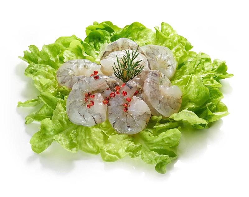 Raw prawns, decorated on lettuce leaves, studio shot