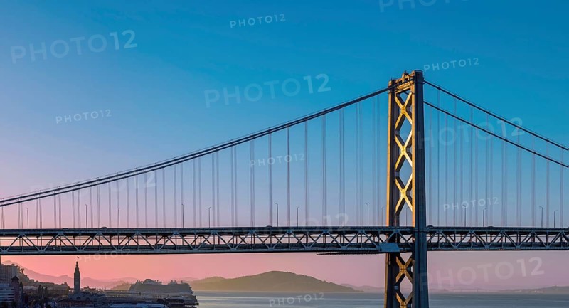 Cruise ship docked near panoramic San Francisco financial skyline near Oakland Bay Bridge.