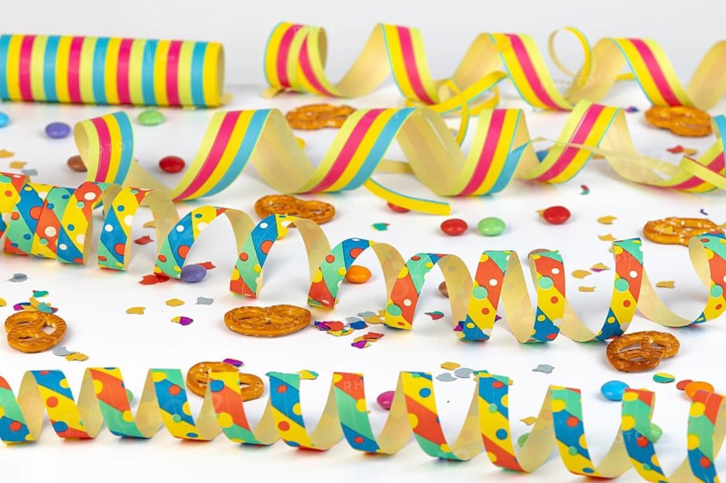 Colourful streamers, confetti and pretzels as party table decorations, carnival