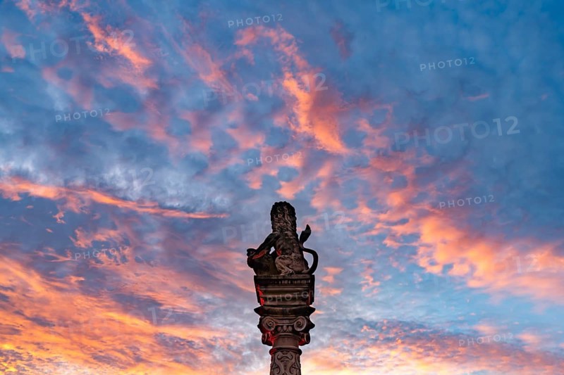 Sunset over the lion of the Löwenbrunnen in Neckarsulm, Baden-Württemberg, Germany, Europe
