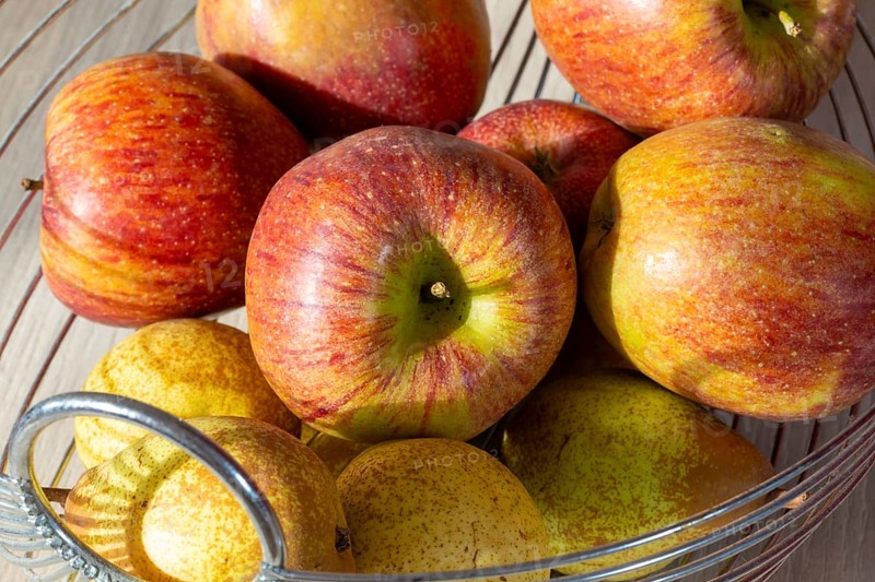 Close-up of apples and pears in the fruit basket