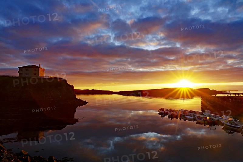Sunset over the sea with reflecting clouds and a calm coast, Stykkisholmur, Snaefelsnes, Iceland, Europe