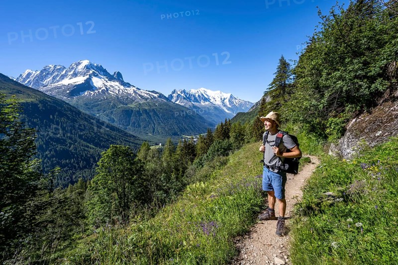 Mountaineer on hiking trail, mountain panorama with glaciated mountain peaks, Aiguille Verte with Aiguille du Midi and Mont Blanc, hike to Aiguillette des Posettes, Chamonix, Haute-Savoie, France, Europe