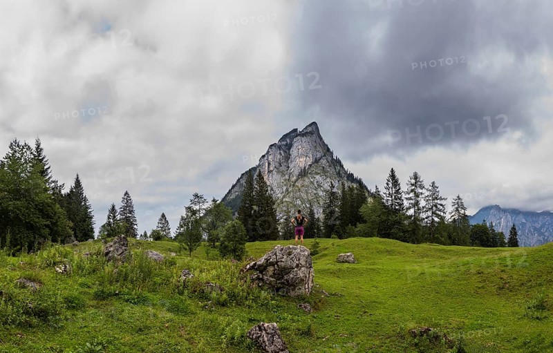 Hiker on the Schartenalm with a view of the Sparber, Osterhorn group, Salzkammergut, Salzburg province, Austria, Europe