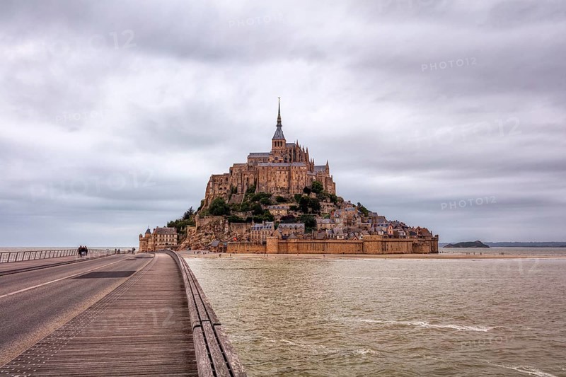 Mont Saint-Michel with access via a long bridge and surrounding water, Le Mont-Saint-Michel