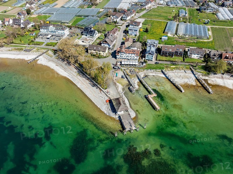 Aerial view of the southern part of the island of Reichenau at low tide and spring-like vegetation, with the landing stage and boat harbour, district of Constance, Baden-Württemberg, Germany, Europe