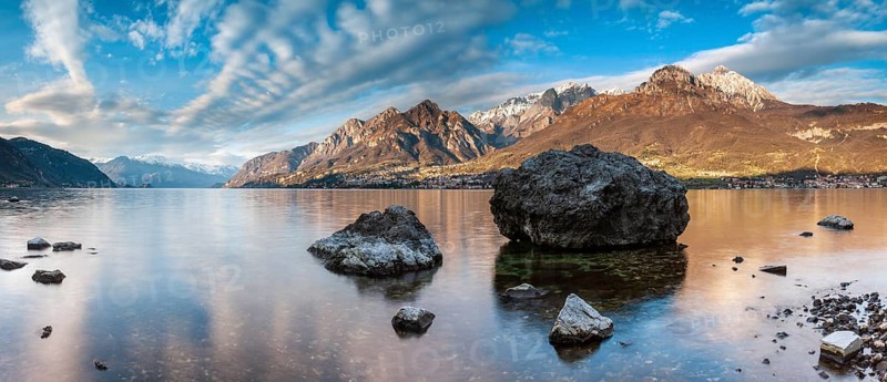 Evening atmosphere at Lago di Como with large boulders in the water, Lombardy, Italy, Europe