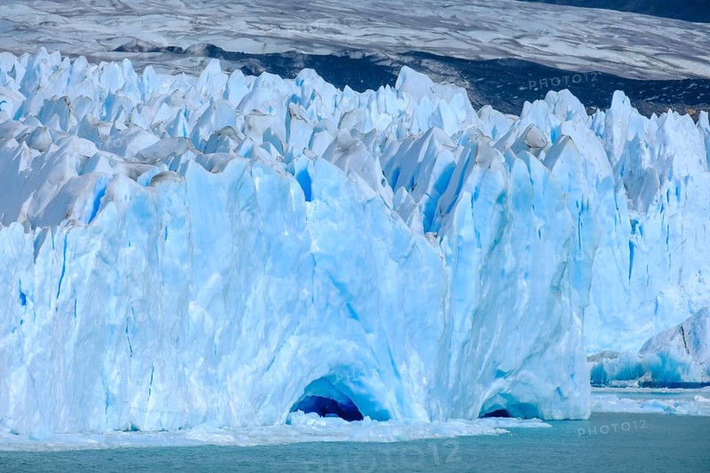 El Calafate, Patagonia, Argentina, Perito Moreno Glacier in Los Glaciares National Park. The Perito Moreno Glacier is part of the Patagonian ice field, the Campo Hielo Sur, the third largest freshwater reserve in the world. It is located in the province of Santa Cruz on Lago Argentino, the country's largest lake. The Perito Moreno Glacier is up to 30 kilometres long and 5 kilometres wide. Its edge is 70 metres high at its highest point. Small icebergs that have broken off from the glacier float in Lago Argentino. The glacier is one of the most beautiful sights in South America and is one of the most visited attractions in Argentina, South America