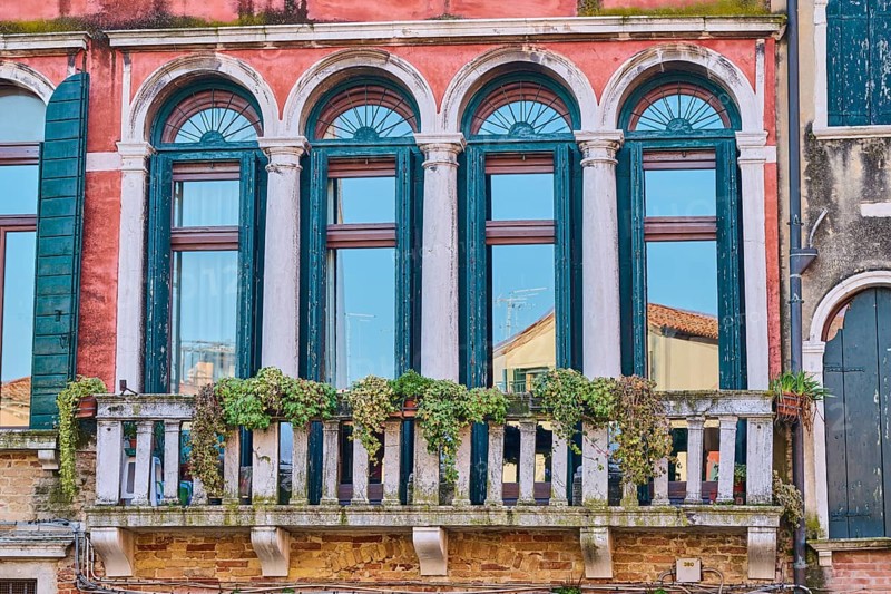 Windows of an old house on 'Campo santa margherita' town square in Venice on a sunny day in winter, Italy, Europe