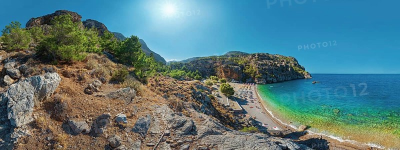Expansive Ahata Beach panorama with beach, mountain backdrop and bright sunlight over the sea, Ahata Beach, Aperi, Karpathos, Greece, Europe