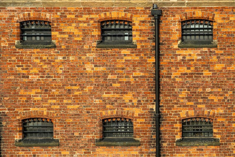 Cell windows with bars, exterior of Victorian jail museum, Lincoln Castle, city of Lincoln, Lincolnshire, England, UK