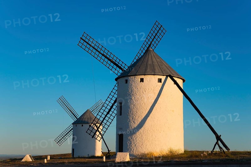 Two large white windmills in the morning sun with long shadows, Campo de Criptana, Ciudad Real province, Castilla-La Mancha, Don Quixote Route, Spain, Europe