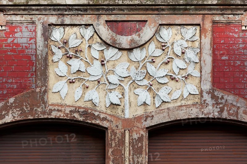 Facade decoration on a Wilhelminian style house for renovation, branches with cherries, detail, Duisburg-Neuenkamp, North Rhine-Westphalia, Germany, Europe