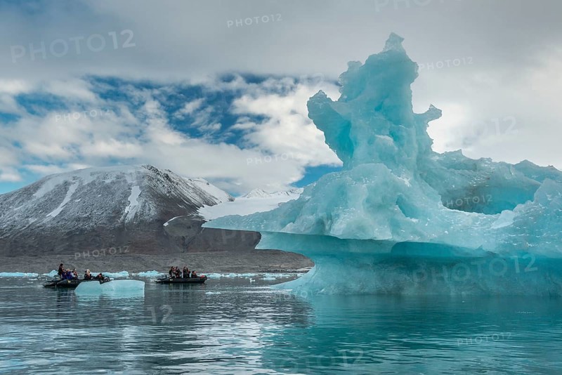 Dinghy with tourists, iceberg, near glacier edge of Monacobreen, Liefdefjord, Woodfjord area, Spitsbergen Island, Svalbard and Jan Mayen archipelago, Norway, Europe