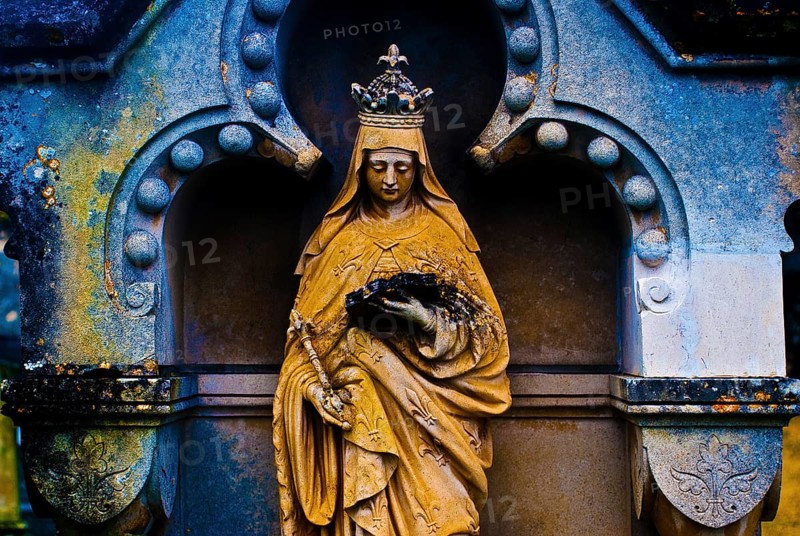 Sculpture of the Virgin Mary reading a book, tombstone in a cemetery, France, color manipulation, Europe