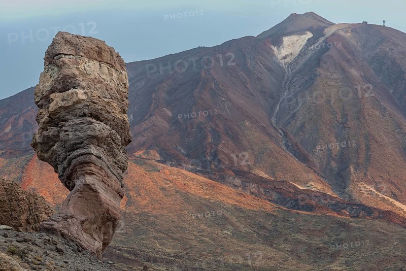 Panorama at sunrise on the Roque Chinchado, also known as the Stone Tree or Finger of God, landmark of the island, Los Roques de Garcia, behind it the Pico del Teide, 3717m, Las Cañadas, Teide National Park, Tenerife, Canary Islands, Spain, Europe