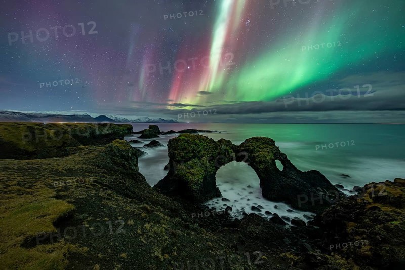 Northern lights over rock structure, coast near Arnarstapi, Snäfellsnes peninsula, Snæfellsnes, West Iceland, Iceland, Europe
