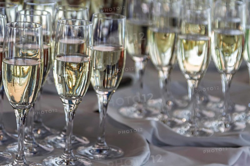 Several full champagne glasses stand on a table and reflect the light, champagne reception, Germany, Europe