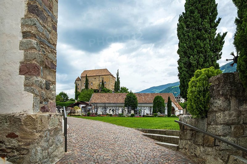 Picturesque cemetery with a view of Scena Castle, on the church hill of Scena above Merano, in the Burggrafenamt, South Tyrol, Italy, for editorial use only, Europe