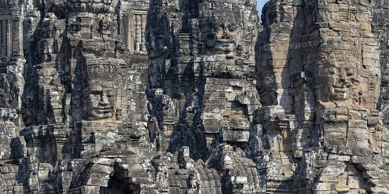 Panoramic image of giant stone-carved faces of the Bodhisattva Lokeshvara, also known as Avalokiteshvara, Bayon Temple, Angkor Thom, UNESCO World Heritage Site, Angkor Wat, Siem Reap, Cambodia, Asia