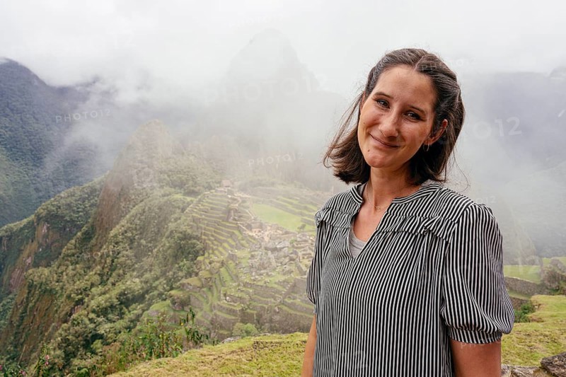 Young woman posing in front of Machu Picchu, Machu Picchu, Cusco Region, Peru, South America