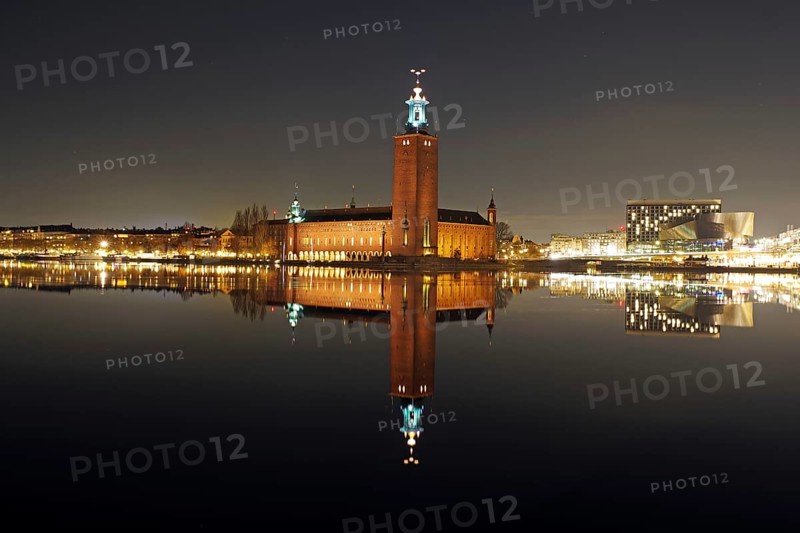 Night city view with illuminated tower and bridges in the background, winter, ice, capital, city hall, Stadshus, Nobel Prize, Stockholm, Sweden, Europe