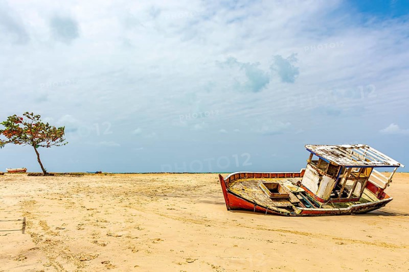 Deteriorated fishing trawler stranded on the beach sand in Olinda, Pernambuco, Olinda, Pernambuco, Brazil, South America