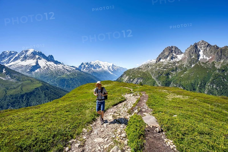 Mountaineer on hiking trail, mountain panorama with glaciated mountain peaks, Aiguille Verte with Aiguille du Midi and Mont Blanc, hike to Aiguillette des Posettes, Chamonix, Haute-Savoie, France, Europe
