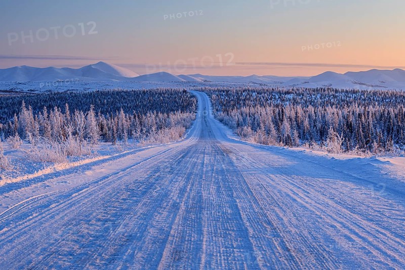 Snow-covered gravel road, highway, ice, snow, cold, mountain landscape, winter, morning mood, Dempster Highway, Yukon, Canada, North America