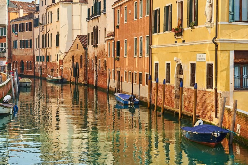 View from 'Casa di otello' over a waterway with boats lying in the water in Venice on a sunny day in winter, Italy, Europe