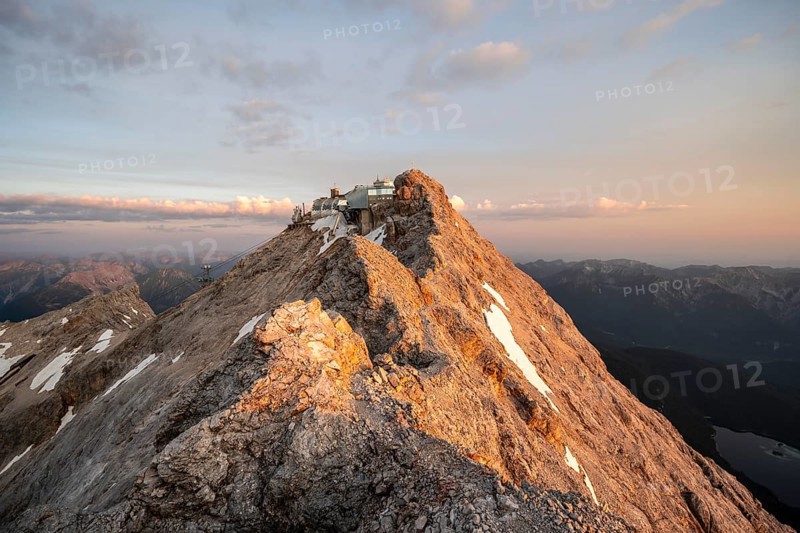Rocky mountain ridge, summit of the Zugspitze with Zugspitze railway, Jubiläumsgrat, at sunrise, Wetterstein range, Bavaria, Germany, Europe