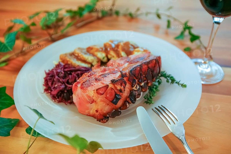 Swabian cuisine, crusty roast Swabian pork, meat dish, pork, crispy, red cabbage, dumplings, typical Swabian, home cooking, cake tin, from the oven, wooden spatula, traditional cuisine, plate, food photography, studio, Germany, Europe
