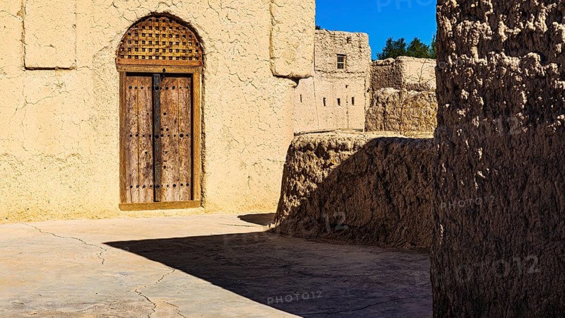 Decorated round arch entrance door in the largest preserved mud town in Oman, Al Bilaad, Al Bilaad Historical Village, Arabian Peninsula, Sultanate of Oman
