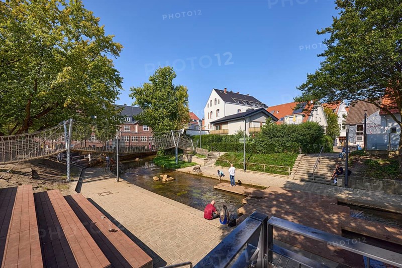 River Salze with suspension bridge for pedestrians and buildings at the Salzhof in Bad Salzuflen, Lippe district, North Rhine-Westphalia, Germany, Europe