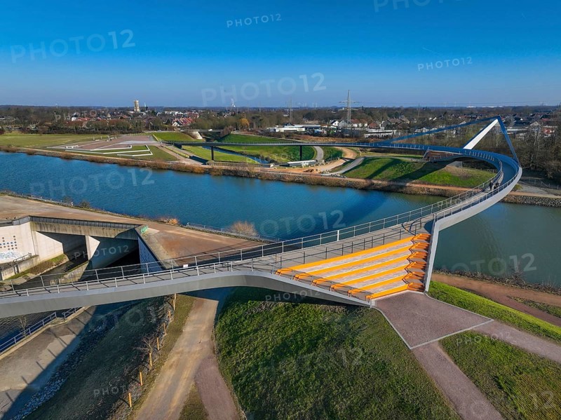Castrop-Rauxel, North Rhine-Westphalia, Ruhr area, Germany - New construction of a bridge Sprung über die Emscher, a pedestrian and cycle bridge over the Emscher and the Rhine-Herne Canal. Construction project EMSCHERLAND, a 37-hectare water and nature adventure park at the water crossroads of the Rhine-Herne Canal and the renaturalised Emscher on the border between Recklinghausen and Castrop-Rauxel. EMSCHERLAND will also be a garden of the future for the International Garden Exhibition 2027. Before the renaturalisation, the Emscher river system was an open, above-ground wastewater channel, mixed water channel with surface water and wastewater