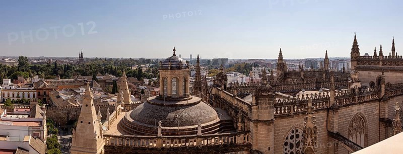 Gothic cathedral with dome in the middle of a historic cityscape, Seville